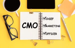 Miles Marketing CMO Chief Marketing Officer acronym with text on notepad